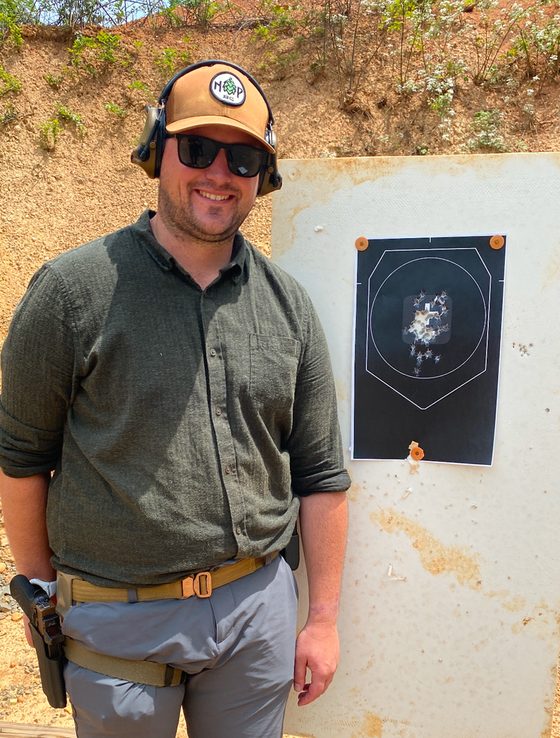 Dr. Greg Huffman standing in front of a target