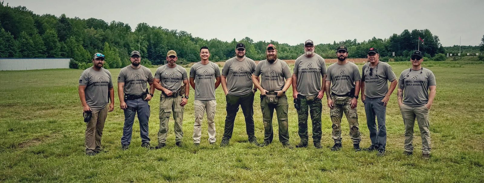 The Scoring Tech team standing in a line on a grass range